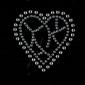 May include: A silver heart-shaped design made of small, round rhinestones.