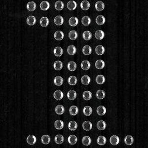 May include: A clear rhinestone design in the shape of the number one. The rhinestones are arranged in a vertical line with a horizontal line at the bottom.
