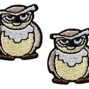 May include: Two brown and white embroidered iron-on patches of owls with black eyes and beaks. The owls are standing with their wings down.
