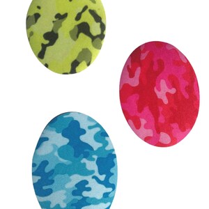 May include: Three round fabric patches with a camouflage pattern. The patches are green, pink, and blue.