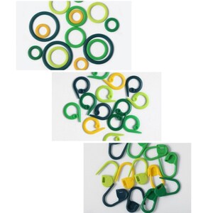 May include: A collection of green and yellow plastic stitch markers. The markers are in the shape of a circle and a hook.