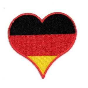 May include: A heart-shaped patch with the German flag colors: black, red, and yellow.