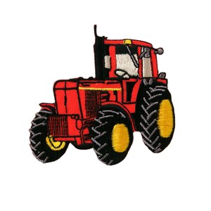 May include: Red tractor with black tires and yellow accents. The tractor has a black exhaust pipe and a white windshield.