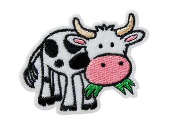 May include: Embroidered iron-on patch of a cartoon cow with black and white spots, eating green grass. The cow has a pink nose and white horns.