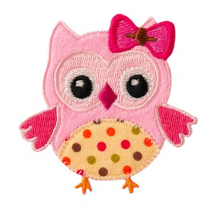 May include: Pink felt owl with a pink bow, black eyes, and a yellow and brown polka dot belly.