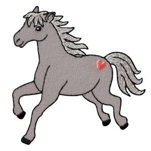 May include: Embroidered gray horse with a red heart on its side. The horse has a white mane and tail, and is depicted in a running pose. The design is likely for a patch or applique.