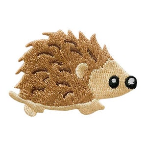 Könnte beinhalten: Gestickter brauner Igel-Patch mit schwarzen Augen und einer weißen Nase. Der Patch ist perfekt, um Kleidung, Taschen oder anderen Bastelarbeiten einen Hauch von Verspieltheit zu verleihen.