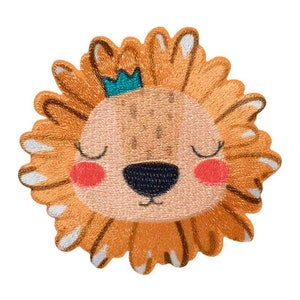 May include: A cartoon lion with a crown on its head. The lion has a light brown face with closed eyes, a black nose, and pink cheeks. The lion's mane is a bright orange colour with white accents.