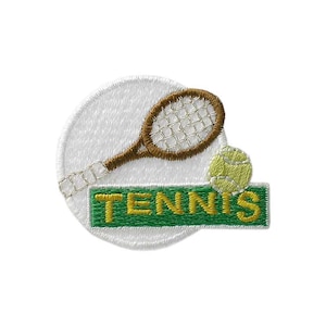 Könnte beinhalten: Gestickter Aufnäher mit Tennis-Motiv. Er zeigt einen Tennisschläger, einen Tennisball und das Wort "TENNIS" in Gelb auf einem grünen Rechteck. Der Aufnäher hat einen weißen, kreisförmigen Hintergrund und eine genähte Umrandung.