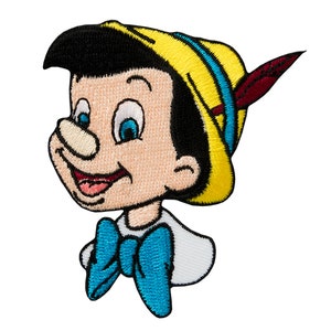 May include: A colorful embroidered patch featuring a cartoon character with a yellow hat, blue bow tie, and a mischievous grin. The character has a large, prominent nose and is looking to the right.