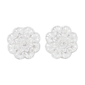 May include: Two white lace doilies with a delicate floral design.
