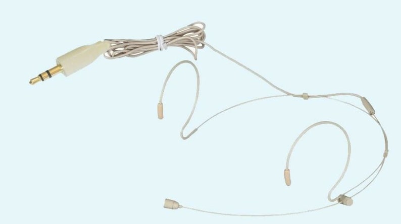 May include: A beige headset microphone with a 3.5mm audio jack. The microphone has three small, beige-colored capsules and a thin, beige cable. The cable is bundled with a white tie. The background is a light blue.