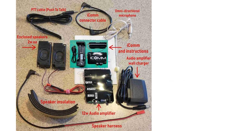 May include: An assortment of communication equipment components, including a 12w audio amplifier, enclosed speakers, and an omni-directional microphone. The kit also includes an iComm connector cable, speaker harness, and a PTT cable. The components are arranged on a light-colored surface.