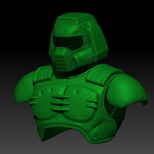 Puede incluir: Un modelo 3D impreso en verde de la parte superior del cuerpo y la cabeza de un personaje de videojuego, que lleva un casco con visera y una pieza de pecho detallada.