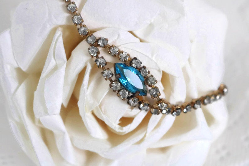 Bracelet Signed Czecho Crystal rhinestone with Blue marquise cut focal piece Gold tone metal.
