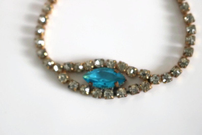 Bracelet Signed Czecho Crystal rhinestone with Blue marquise cut focal piece Gold tone metal.