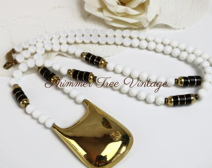 ANNE KLEIN Long white, gold and black beaded Lion head pendant necklace