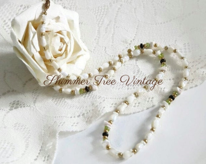 Shell tulip flower long strand necklace with dainty shell and wood accents.