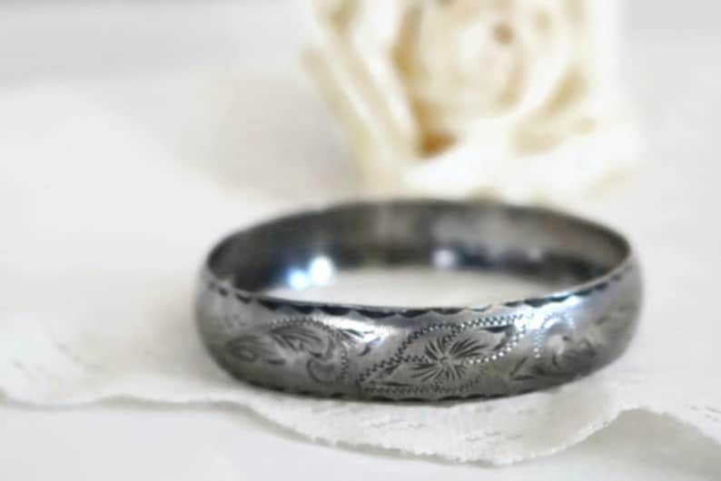 Sterling Silver bangle Bracelet with scrolling feather leaf etching.