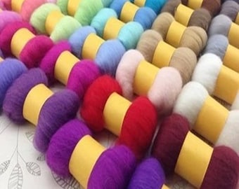 May include: A collection of colorful wool roving in various shades, arranged in rows and wrapped in yellow paper. The wool is soft and fluffy, perfect for felting or spinning.