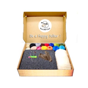 May include: An open cardboard box with a sheep logo and the text "Be a Happy Felter!"  The box contains a felting kit with colorful wool, felting needles, a foam mat, and a white wool roving.