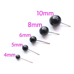 May include: Five black plastic safety eyes with metal pins in different sizes: 4mm, 5mm, 6mm, 8mm, and 10mm.