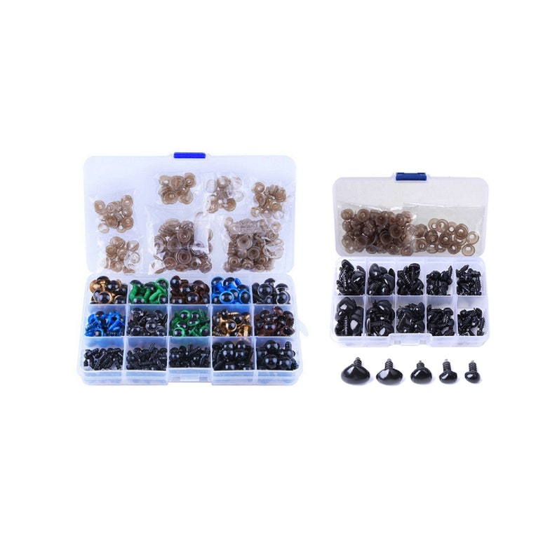 May include: Two clear plastic containers filled with assorted plastic safety eyes for crafts. The containers are filled with different sizes and colors of eyes, including black, brown, gold, blue, and green. There are also several extra eyes in the bottom right corner of the image.