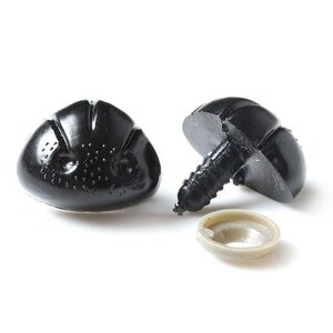 May include: Two black plastic safety eyes with a screw back and a washer. The eyes have a textured surface and a raised design.