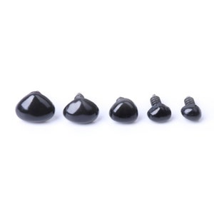 May include: Five black plastic safety eyes with screw backs in various sizes. The eyes are arranged in a row from largest to smallest.