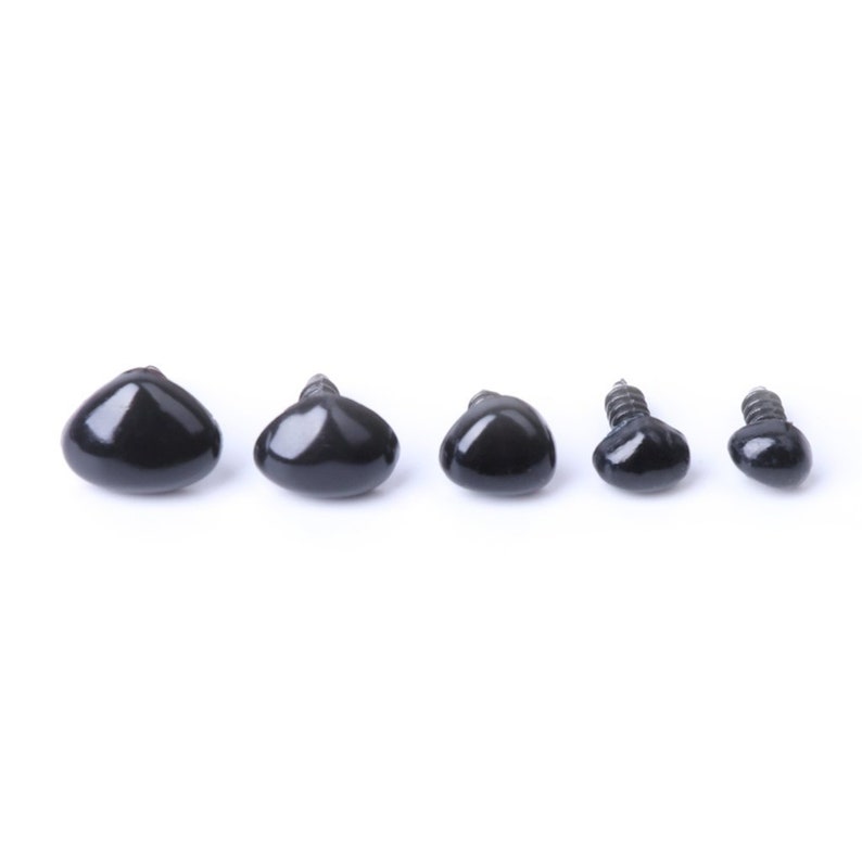 May include: Five black plastic safety eyes with screw backs in various sizes. The eyes are arranged in a row from largest to smallest.