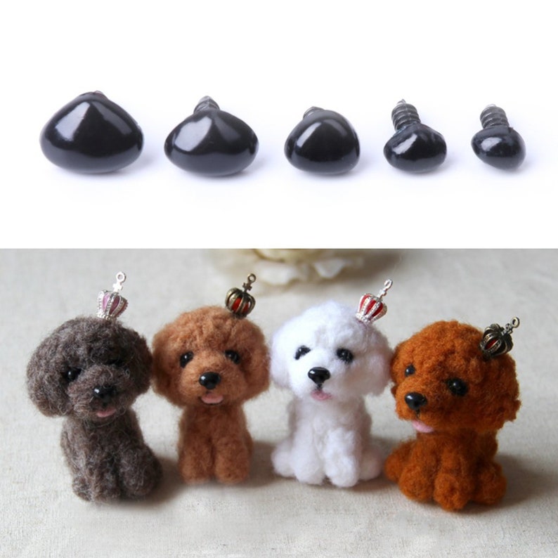 May include: Assortment of black plastic safety eyes with screw backs in various sizes. The eyes are shown next to four small felt toy dogs wearing crowns.