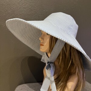 A romantic wide-brim hat in soft blue and white gingham, designed for effortless elegance and timeless summer style. Cotton hat image 12