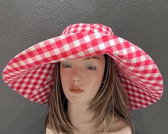A romantic wide-brim hat in soft red and white gingham, designed for effortless elegance and timeless summer style. Cotton hat