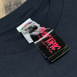 May include: Black t-shirt with a white tag that says "Hot Topic" and "everything about the music".