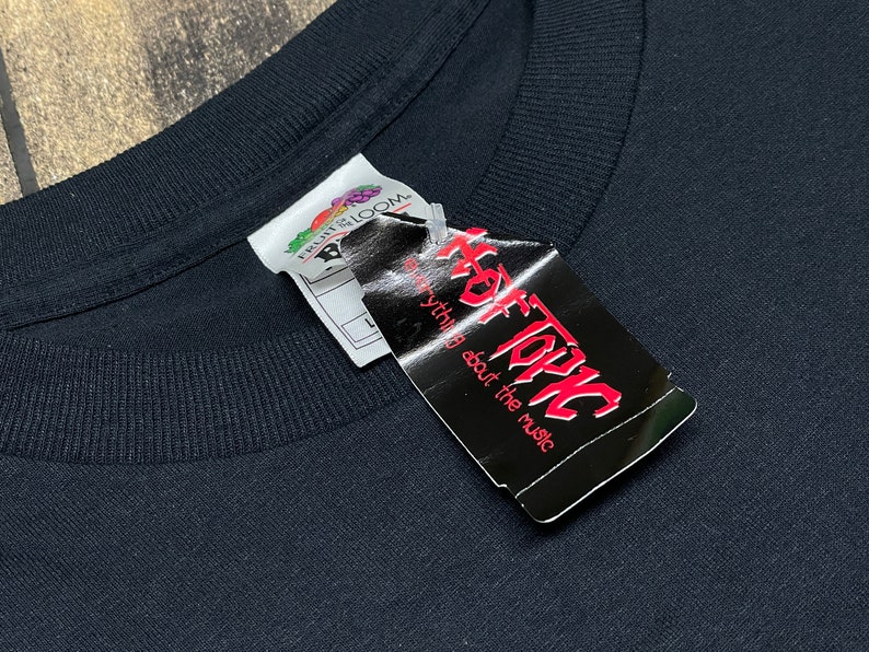May include: Black t-shirt with a white tag that says "Hot Topic" and "everything about the music".