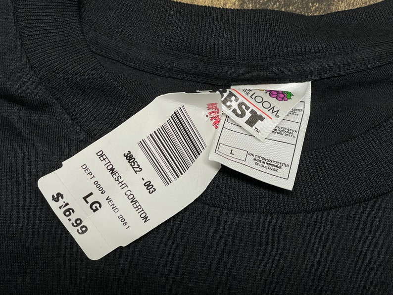 May include: A black t-shirt with a white tag that says "DEFTONES-HT COVERTON" and "380522 - 003". The tag also says "DEPT 0009 VEND 2081" and "LG". The price is $16.99.