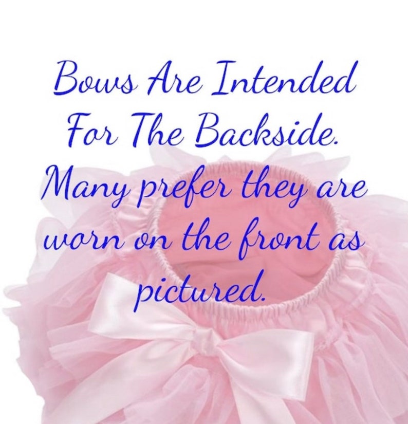 May include: A pink tulle tutu with a large white satin bow. The text "Bows Are Intended For The Backside. Many prefer they are worn on the front as pictured." is written in blue text on the tutu.