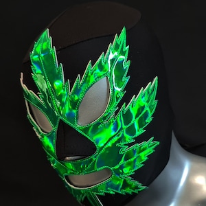 May include: A black wrestling mask with a green iridescent leaf design. The mask has eye holes and a mouth hole.