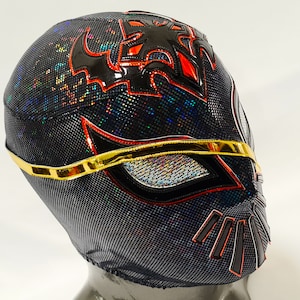 Op de afbeelding: Zwart worstelmasker met rode en gouden accenten. Het masker heeft een gedetailleerd ontwerp met een zwart en rood patroon aan de voorkant. Het masker is gemaakt van rekbaar materiaal en heeft een gaas dat de ogen bedekt.