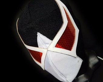 May include: A white wrestling mask with a red star design. The mask has a black fabric backing and a white leather trim.