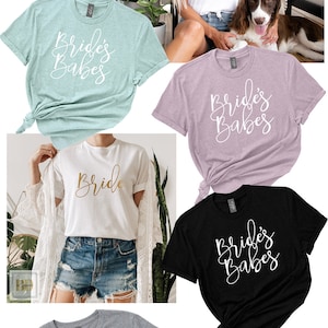Op de afbeelding: Een verzameling van tien T-shirts in verschillende kleuren, met de tekst "Bride" en "Bride's Babes". De shirts worden getoond op modellen die jeans en casual kleding dragen.