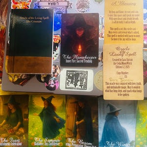 May include: A collection of Oracle of the Living Spell cards and a small book titled The Grimoire. The cards feature illustrations of a figure in a witch hat, including The Flamekeeper, The Feast, The Summer, The Besom, and The Winter.