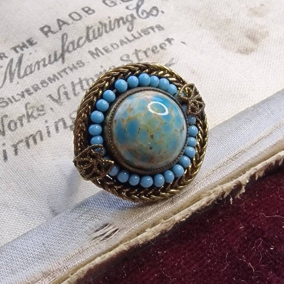 Art Nouveau ring made of brass with a glass cabochon and a glass beaded wreath, brass, true vintage, light blue
