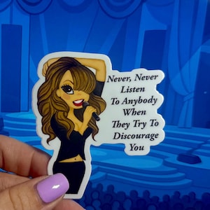 May include: A sticker featuring a cartoon illustration of a singer holding a microphone, with the text "Never, Never Listen To Anybody When They Try To Discourage You". The singer has long brown hair and is wearing a black outfit.