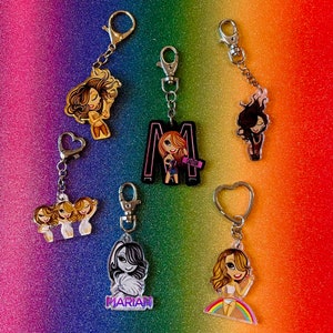 May include: A set of ten colourful keychains featuring cartoon characters. Each keychain has a different design and includes a silver metal ring. The keychains are perfect for adding a touch of personality to your keys or bag.