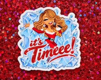 May include: A die-cut sticker featuring a cartoon woman with long wavy brown hair wearing a red dress with white fur trim, holding a microphone, emerging from blue ice shards with the red glittery text that reads it's Timeee!