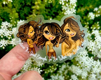 May include: A transparent sticker showing three cartoon women with brown hair and skin, wearing tan tops and brown trousers. Each woman has a butterfly in her hair. The text "Believe It's Good Enough To Be What You Really Are" is on the sticker.