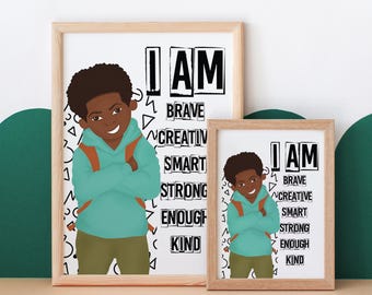 May include: Two framed prints with a black and white design featuring a cartoon illustration of a young Black boy with a backpack. The text on the prints reads "I AM" and lists positive affirmations such as "brave", "creative", "smart", "strong", "enough", and "kind".