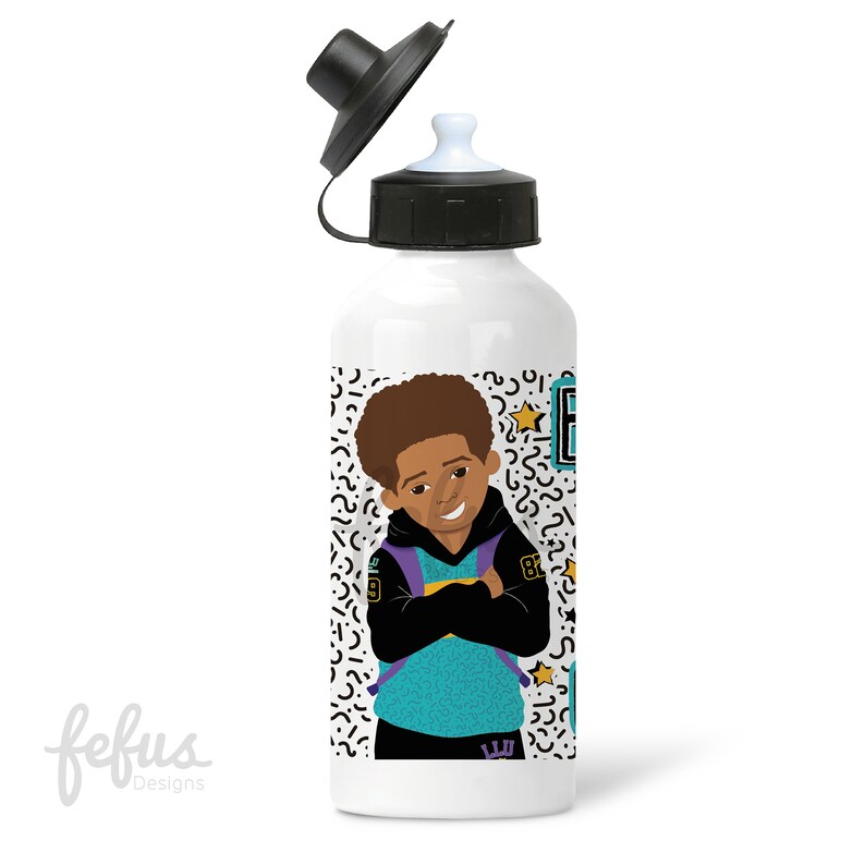 May include: White water bottle with a black lid and a colorful design featuring a cartoon boy wearing a turquoise and black hoodie with a purple backpack. The design also includes a yellow star and a geometric pattern.