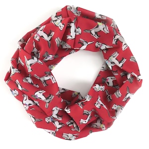 May include: Red infinity scarf with a white dog print pattern.